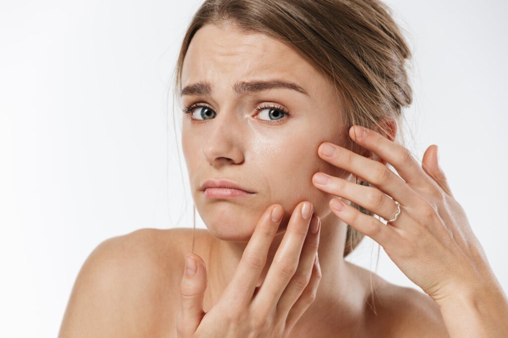 Young woman touching her face